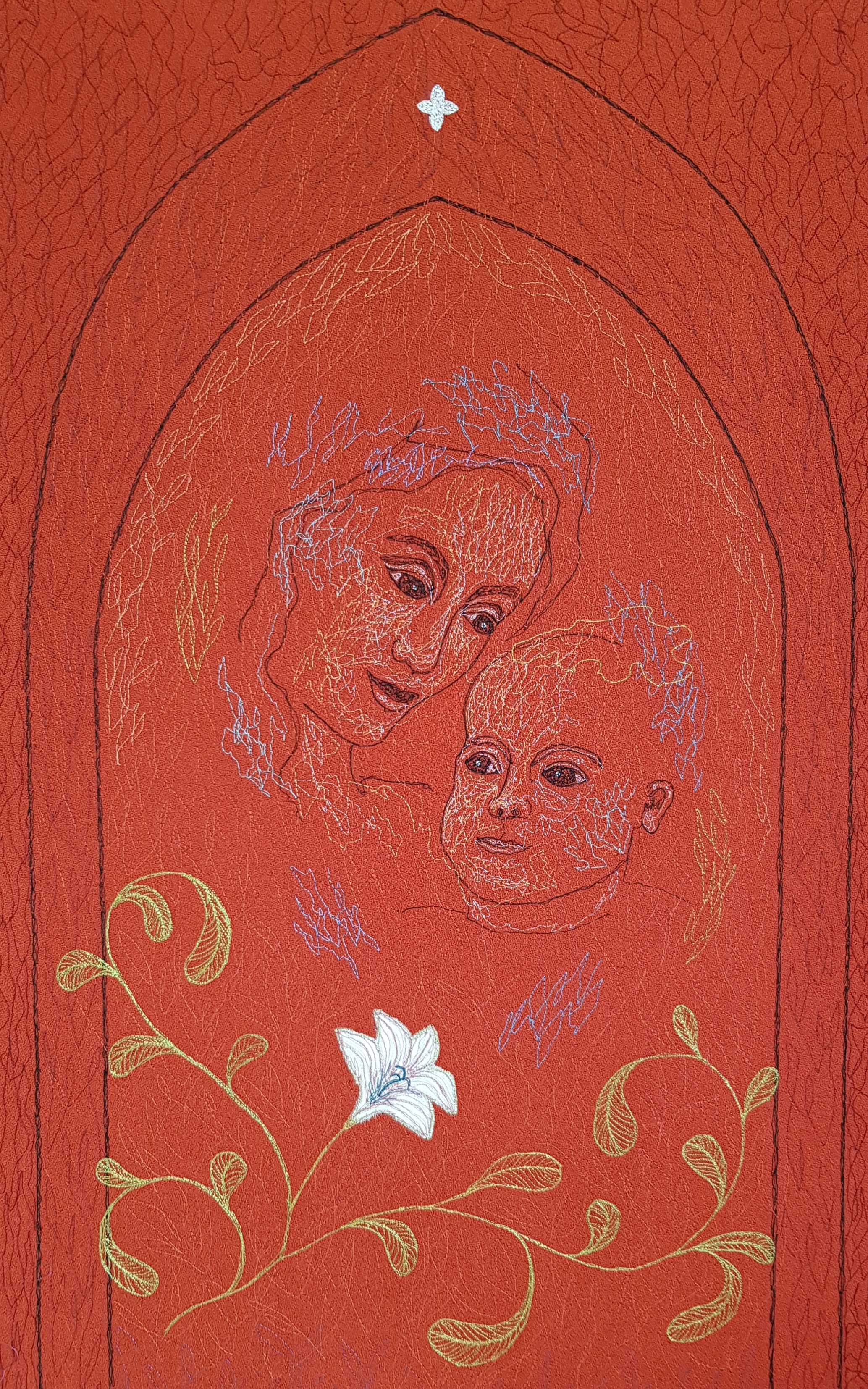 Punasävyinen kirjaliina jossa Madonna ja Jeesus-lapsi kuviointi. 